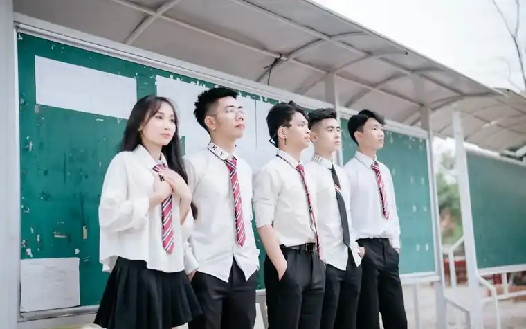 대학 캠퍼스 게시판 앞에서 모집요강을 살펴보는 학생