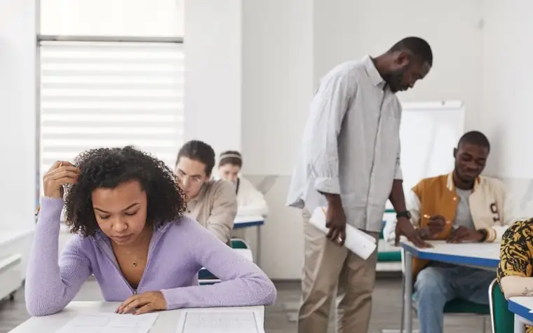 Students taking an exam together in a classroom
