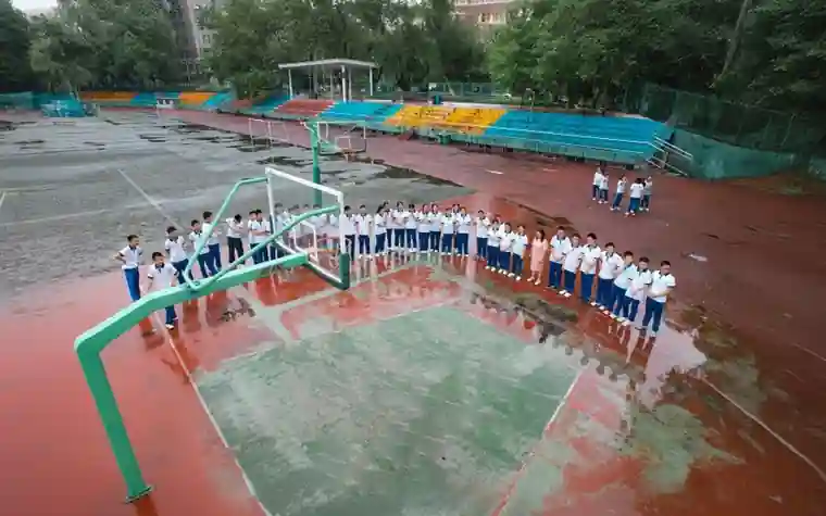 Students lined up on a basketball court on a school sports ground